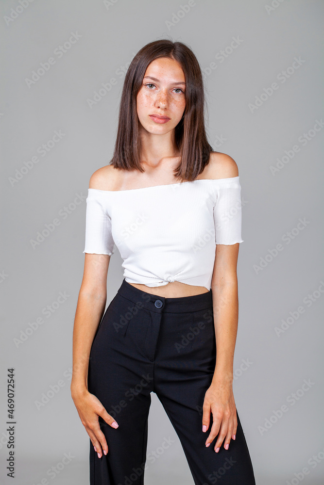 Young beautiful girl in studio isolated on gray background Young beautiful girl in studio isolated on gray background