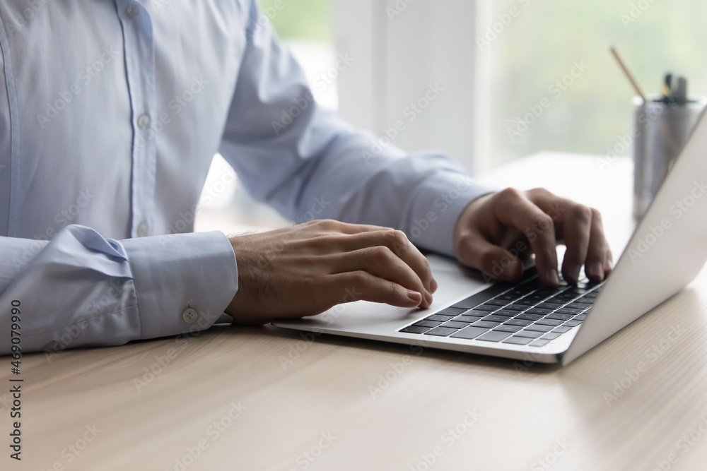 Close up young businessman entrepreneur manager typing on laptop keyboard, typing sending email or message, working distantly on online project, internet correspondence, remote communication concept. Close up young businessman entrepreneur manager typing on laptop keyboard, typing sending email or message, working distantly on online project, internet correspondence, remote communication concept.