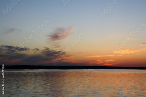 Sunset on Lake Ladoga  blue sky  clouds  forest on the distant shore - view from the ship