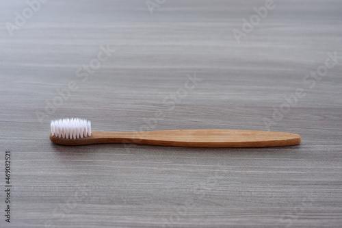 Close-up photo of a toothbrush against a wood texture background from various angles