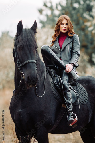 Beautiful young woman posing with a horse outdoors, close up © Inna888stock