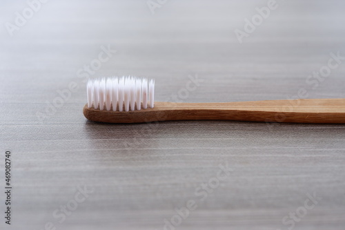 Close-up photo of a toothbrush against a wood texture background from various angles