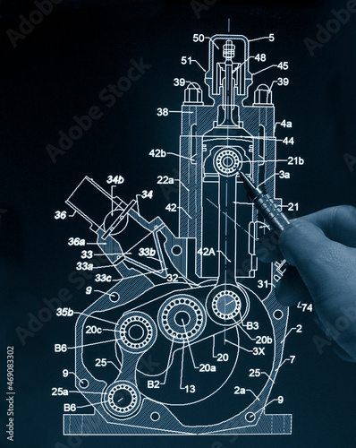 engineer working on computer at 2T motor prototype blueprint design