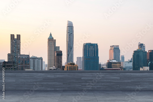 Panoramic Bangkok skyline view, concrete observatory deck on rooftop, sunset. Luxury Asian corporate and residential lifestyle. Financial city downtown, real estate. Product display mockup empty roof