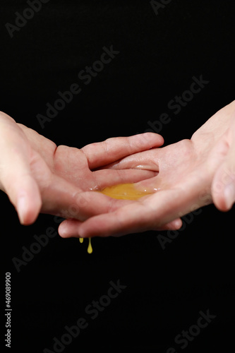 spreading chicken yolk on the palms