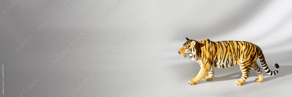 Tiger symbol of the Chinese new year 2022. Figurine of tiger isolated on white background with shadows. Copy space.