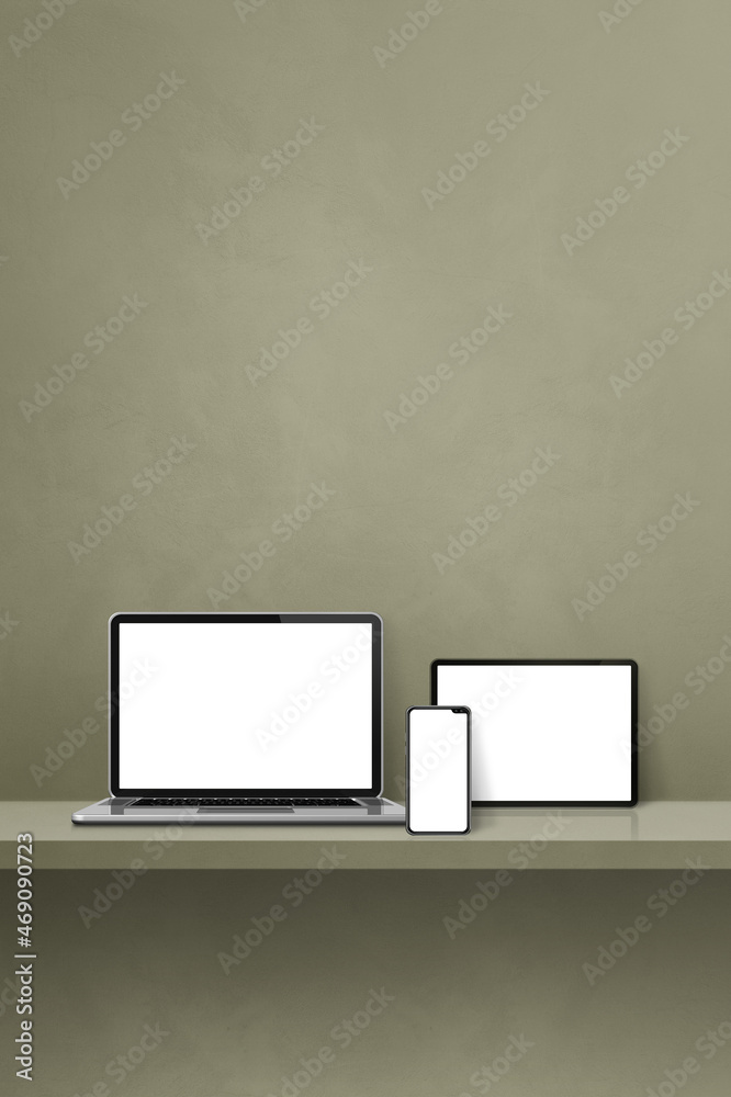 Laptop, mobile phone and digital tablet pc on green wall shelf. Vertical background Laptop, mobile phone and digital tablet pc on green wall shelf. Vertical background
