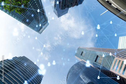 Photography Social media icons hologram over low angle shot of Singapore skyscrapers, Southeast Asia
