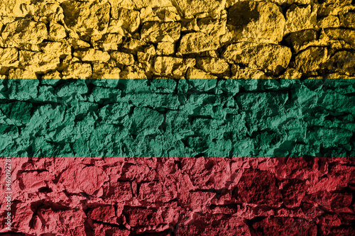 Lithuanian flag depicted on a stone wall. The texture of the stone blends perfectly with the colors of the banner © Ungrim