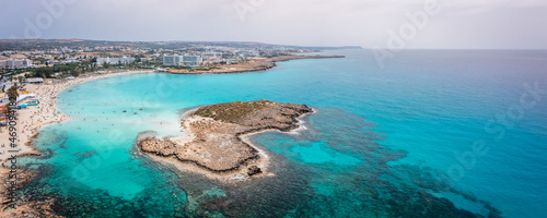 Aerial view of the most famous beaches in Cyprus - Nissi Beach. White sand beach with azure waters. Beautiful beach and panoramic views of Cyprus photo