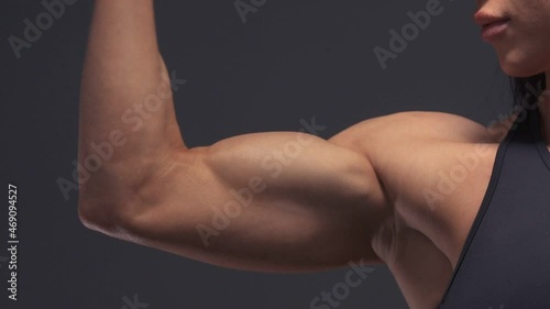 Muscular female bodybuilder woman workout arms: biceps and triceps in the gym. Sport and health care concept photo