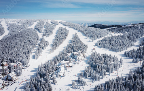 Panorama of the ski resort Kopaonik in Serbia. Kopaonik National Park, winter landscape in the mountains, coniferous forest covered with snow photo