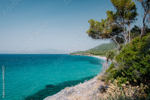 Blue sea on the Turkish coast. Azure water and trees as a background. Dilek National Park, Kusadasi, Turkey