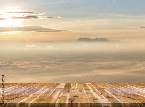 Sunrise in mountain mist with Empty wooden table