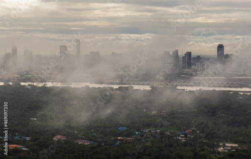 Bangkok, thailand -Sep 16, 2021 : An impressive aerial top view of skyscrapers at downtown Bangkok city along the chao phraya river in morning fog. No focus, specifically. © num