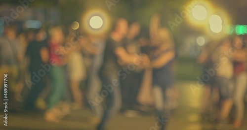 Dancing fiesta in the night. Many couples dance Latin-American social dances. Open-air music festival. Young people enjoy open-air salsa dancing festival