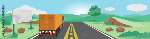 Poster and landscape view of Truck container car cargo trip on the asphalt road. Empty billboard beside the road. Driving on the meadow with mountain for background under the blue sky.