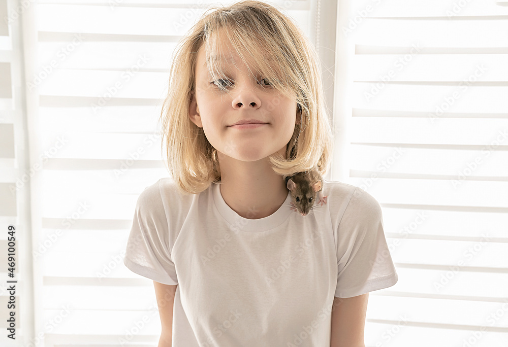 The girl with the rat plays at home. Close-up. Happy child. The girl with the rat plays at home. Close-up. Happy child.