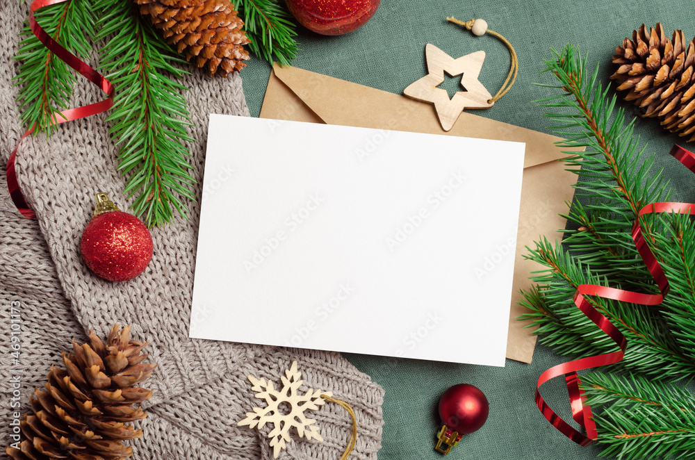 Christmas or New Year greeting card mockup with envelope and festive decorations with fir tree branches Christmas or New Year greeting card mockup with envelope and festive decorations with fir tree branches