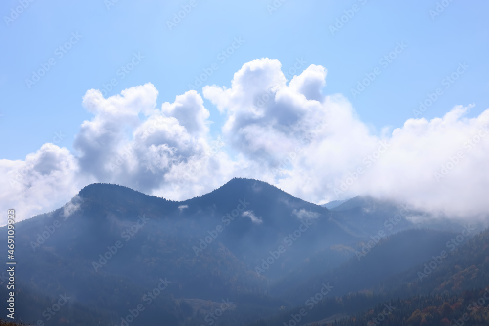 Picturesque view of beautiful mountains covered with fog