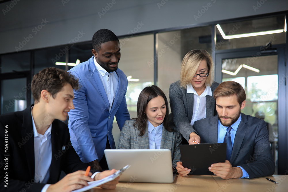 Group of business people in a meeting discussing and planning a project Group of business people in a meeting discussing and planning a project