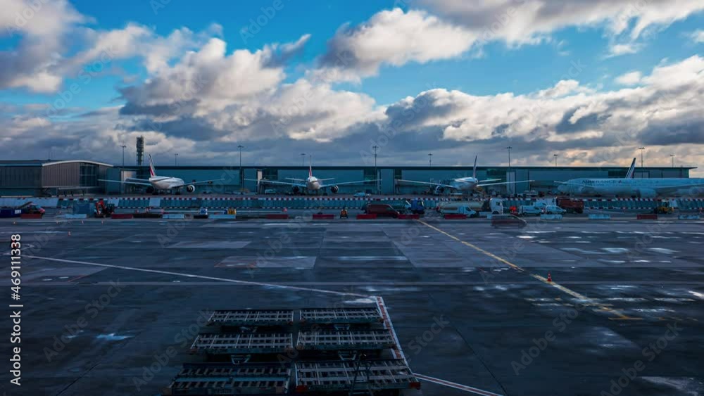 Beautiful time lapse view of the Airport and huge airplanes standing on the runway getting ready for the flight. Clouds floating over the airport.