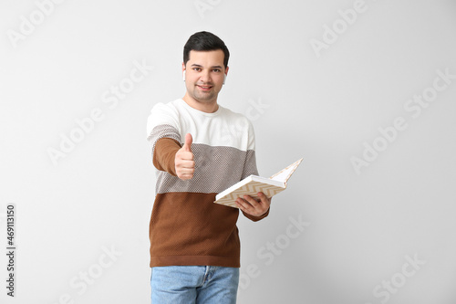 Young man with book and ear...