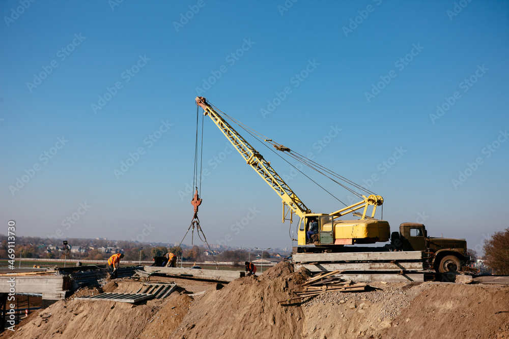 crane on the construction of the bridge on a warm spring morning crane on the construction of the bridge on a warm spring morning