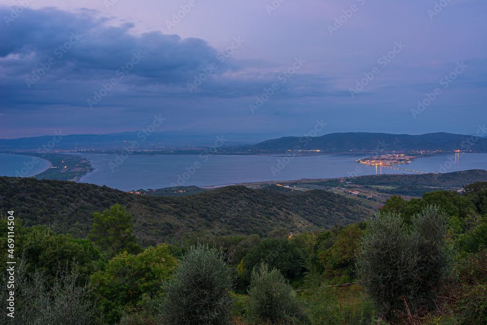 Sunset twilight landscape at Orbetello lagoon natural park, beautiful sky scenic coast aerial view from Monte Argentario, tourism destination Tuscany Italy