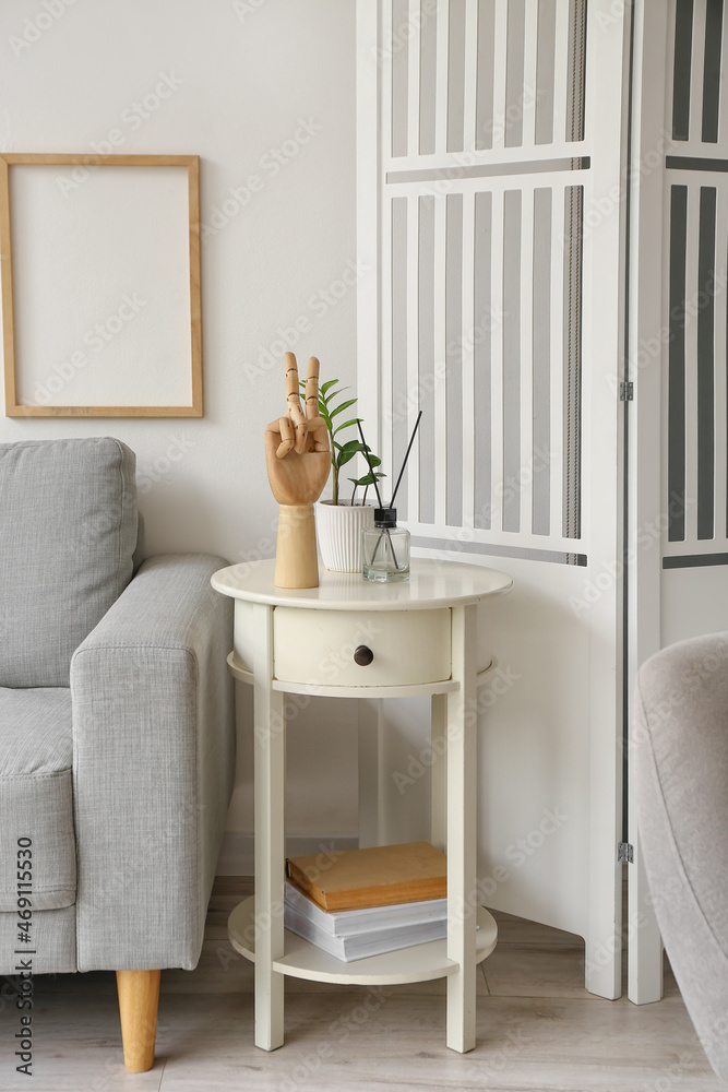 Fototapeta premium Wooden hand and reed diffuser on white table