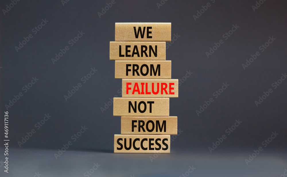 Failure or success symbol. Wooden blocks with words We learn from failure not from success. Beautiful grey background, copy space. Business, learn from failure or success concept. Failure or success symbol. Wooden blocks with words We learn from failure not from success. Beautiful grey background, copy space. Business, learn from failure or success concept.