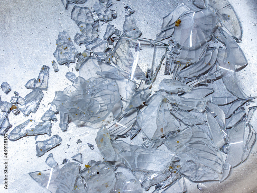a lot of shards of glassware in a metal sink after careless dishwashing a lot of shards of glassware in a metal sink after careless dishwashing