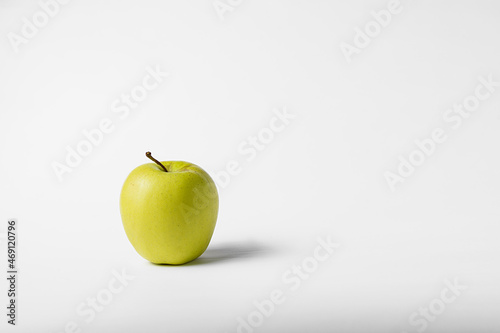 Green and yellow apple on a white background