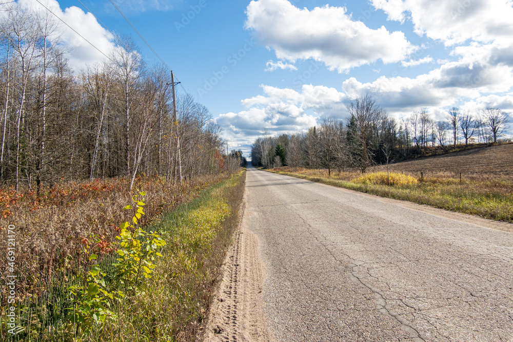 A rural roadside at harvest time with puffy white clouds. Shot in the farm counrty of the Ottawa Valley (Ontario, Canada) in early November. A rural roadside at harvest time with puffy white clouds. Shot in the farm counrty of the Ottawa Valley (Ontario, Canada) in early November.