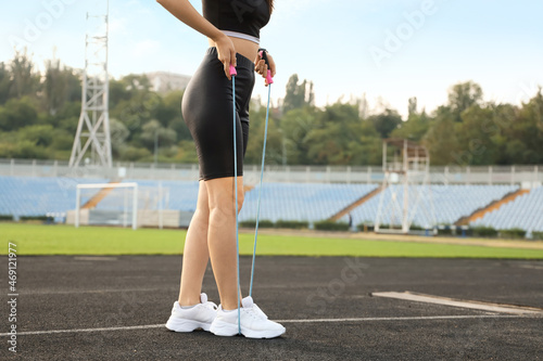 Sporty young woman training with skipping rope in the stadium © Pixel-Shot