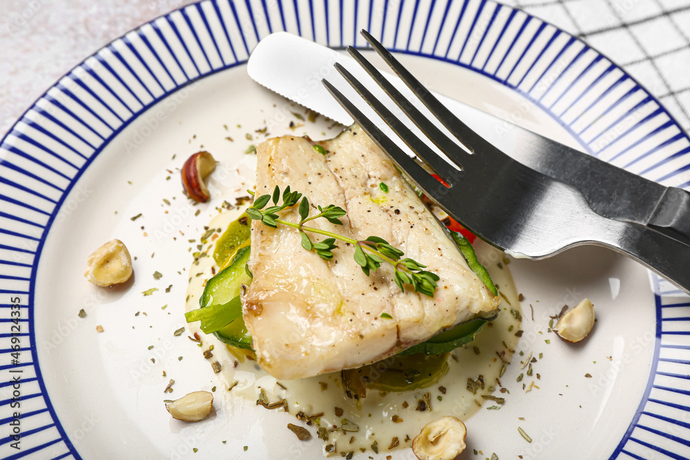 Plate of delicious sea bass fish on table, closeup Plate of delicious sea bass fish on table, closeup