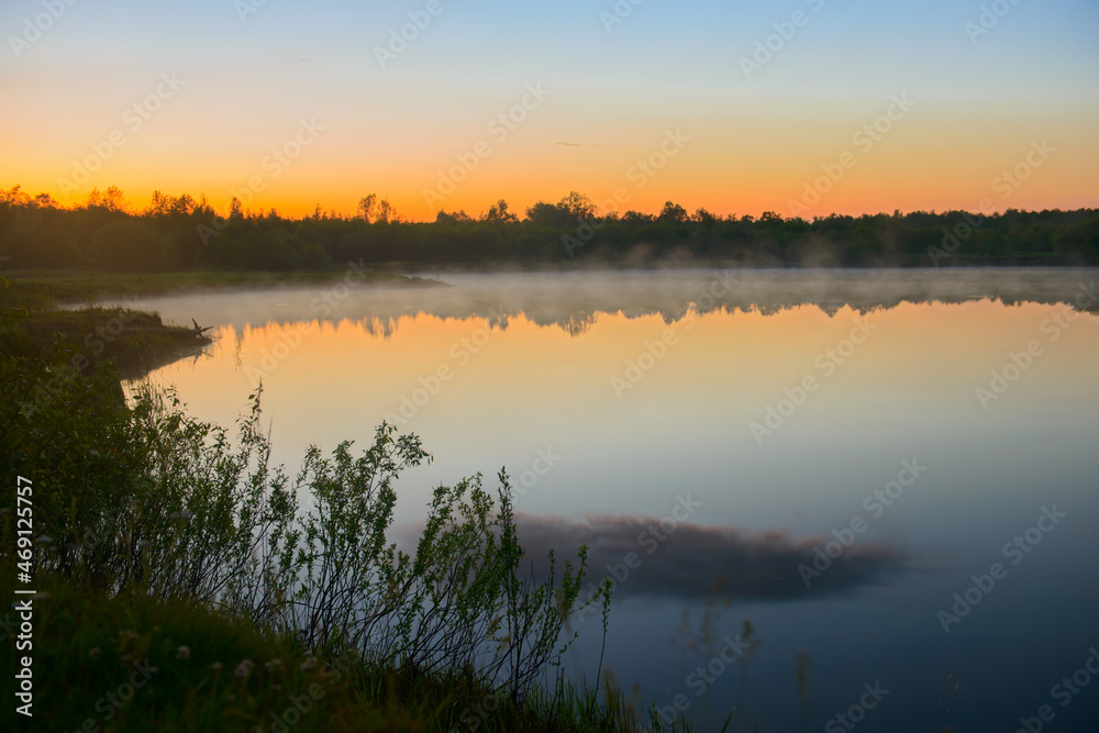 Fototapeta premium Fog over the lake on a beautiful summer evening