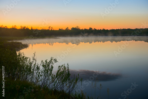 Fog over the lake on a beautiful summer evening