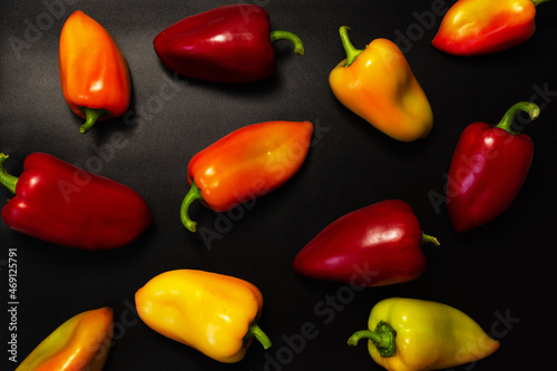 Ripe Yellow, Red and Green Peppers in Vegetables Market