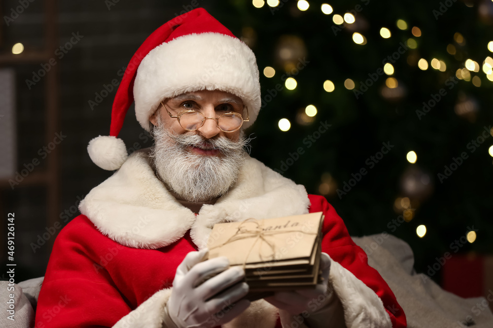 Santa Claus with letters at home on Christmas eve Santa Claus with letters at home on Christmas eve