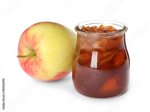 Tasty apple jam in glass jar and fresh fruit on white background