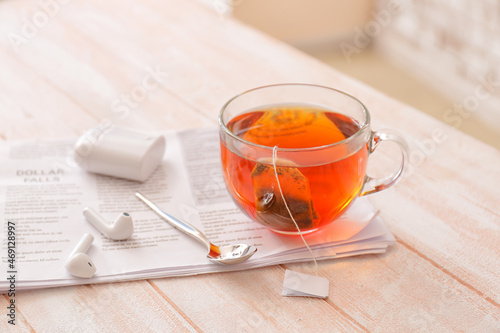Glass cup of hot tea, newsp...