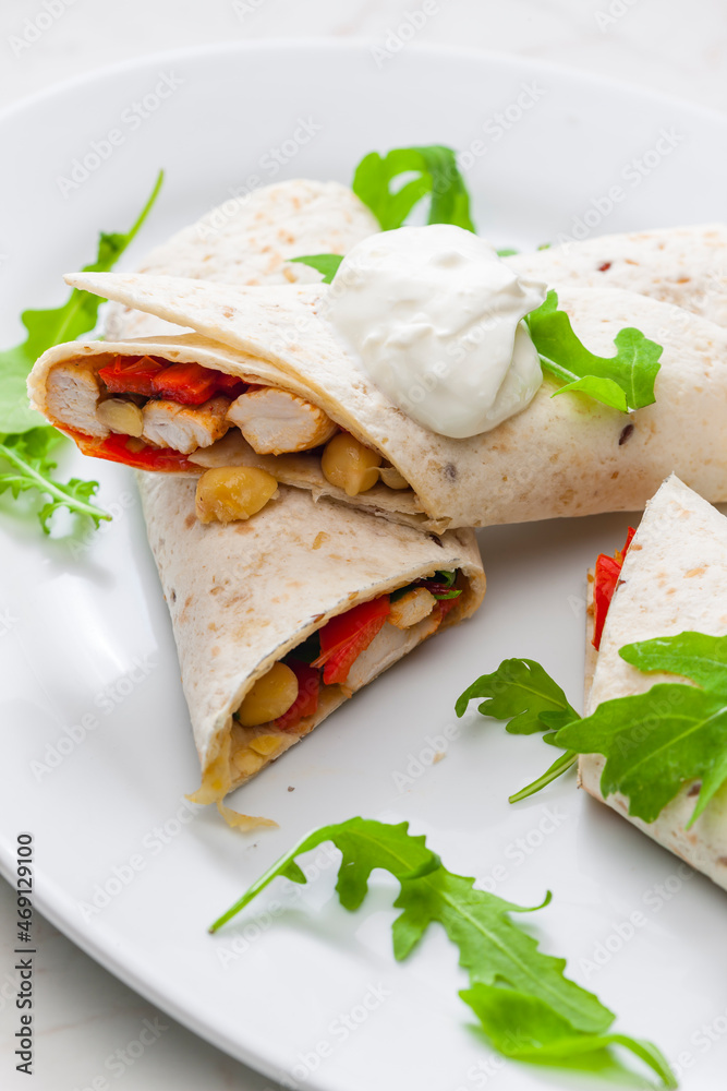 tortilla filled with chicken meat, red pepper and beans