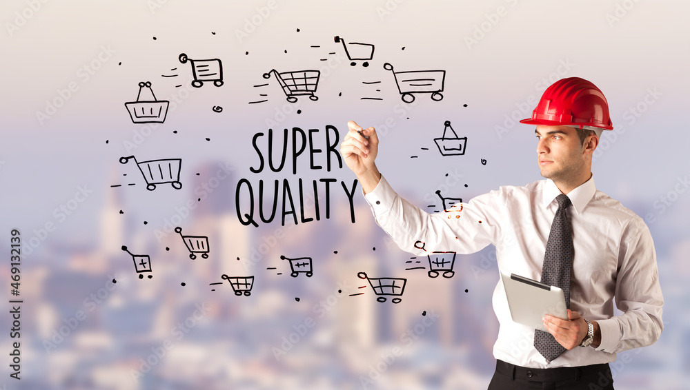 Young businessman with helmet drawing sale sign Young businessman with helmet drawing sale sign