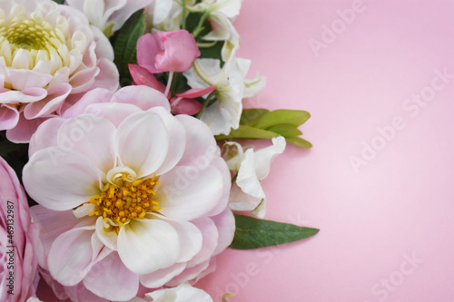 Delicate blossoming light pink flowers dahlias frame, blooming pastel flowers festive background, soft bouquet floral card, selective focus, shallow DOF, toned