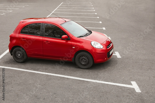 Modern red car on parking lot outdoors