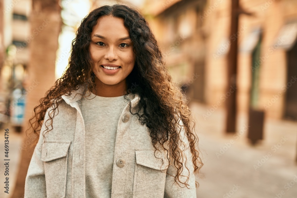 Young latin woman smiling happy standing at the city. Young latin woman smiling happy standing at the city.