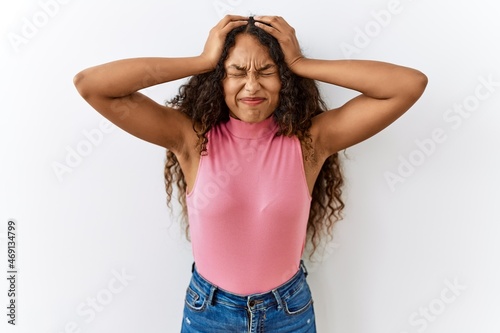 Obraz na plátně Beautiful hispanic woman standing over isolated background suffering from headache desperate and stressed because pain and migraine