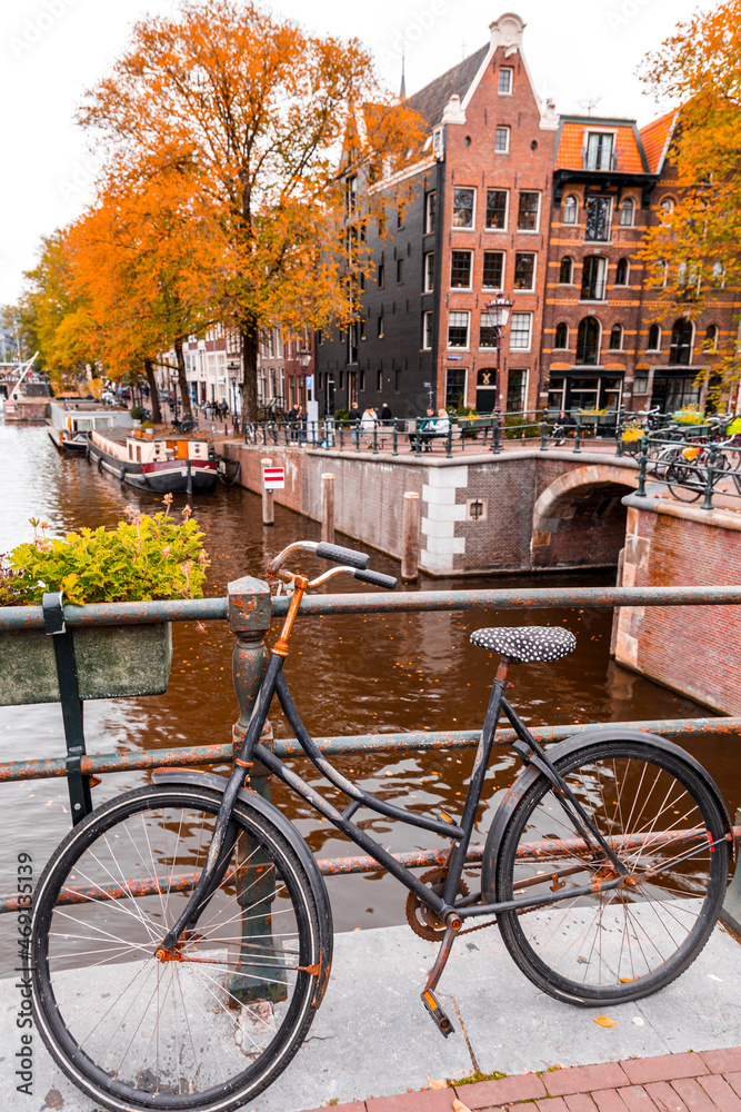 Abandoned city bike parked on a brdige over a canal in Amsterdam