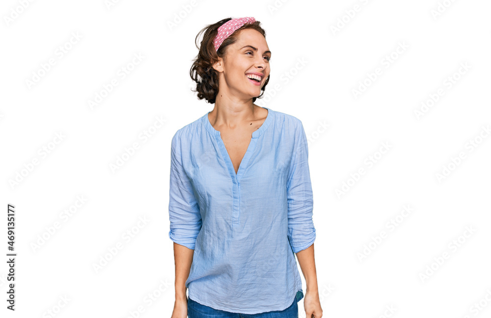 Young hispanic woman wearing casual clothes looking away to side with smile on face, natural expression. laughing confident. Young hispanic woman wearing casual clothes looking away to side with smile on face, natural expression. laughing confident.